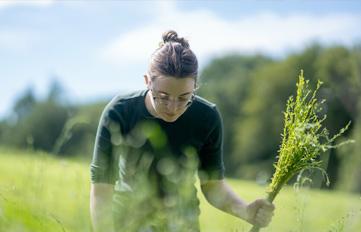 UNH student working outside on farm