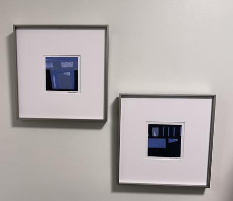 two small blue artworks on the wall