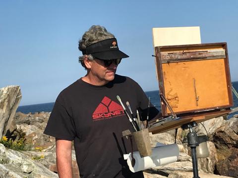 A man in a field painting