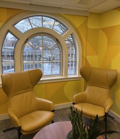 two chairs sitting in a yellow room