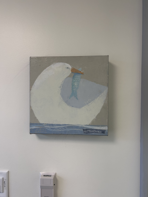 A painting of a seagull with a fish