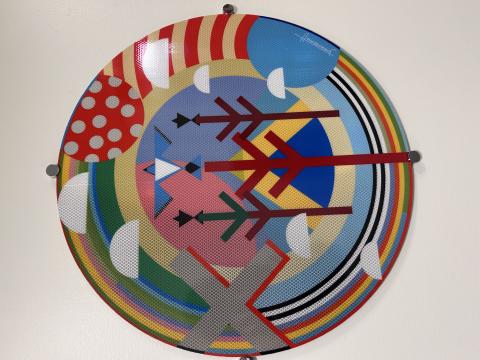 A colorful circle of shapes and lines on reflective material