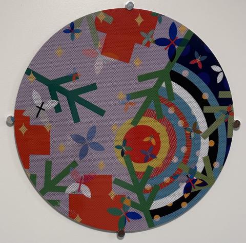 A colorful circle of shapes and lines on reflective material