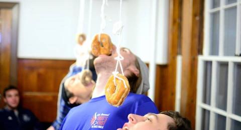 students competing in donut eating contest