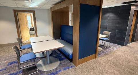Photo of a lounge space in Hetzel Hall showing tables and chairs.