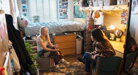 Photo of students in a decorated dorm room.