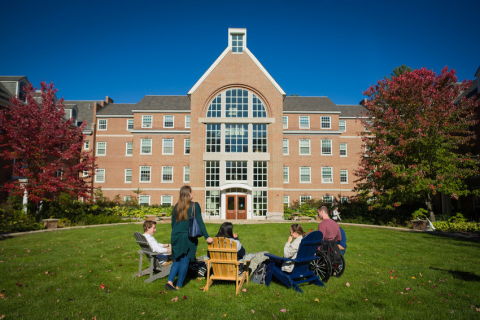 students sitting on the front lawn of Congreve Hall