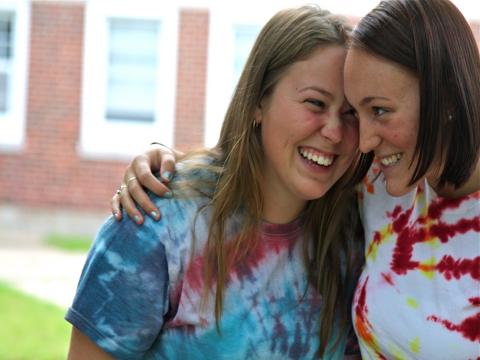 two students hugging and smiling