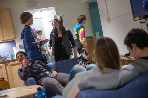 Students socializing in a housing common area