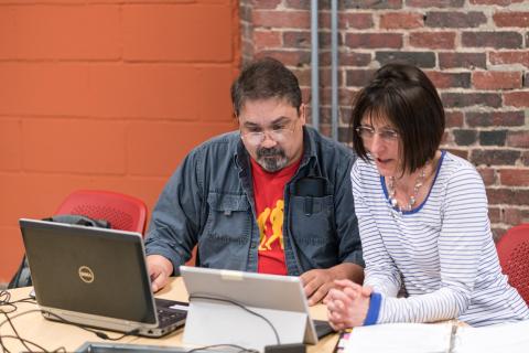 two people viewing a computer screen