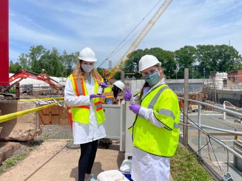 The author holds a sample collected at the Wallingford wastewater treatment plant with the help of graduate student Carmela Antonellis.