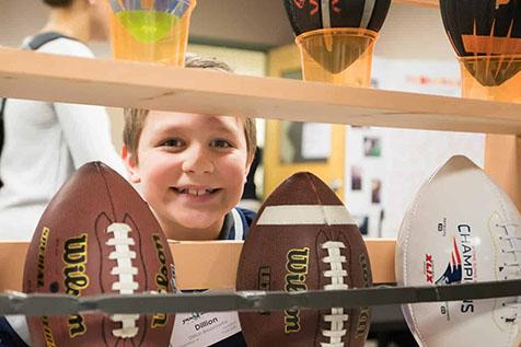 Kid Smiling With Footballs