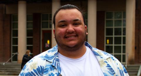 Student standing in front of the Dimond Library