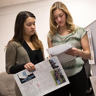 students looking at paper together