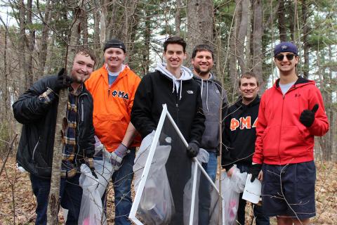 Phi Mu Delta picking up trash in the woods