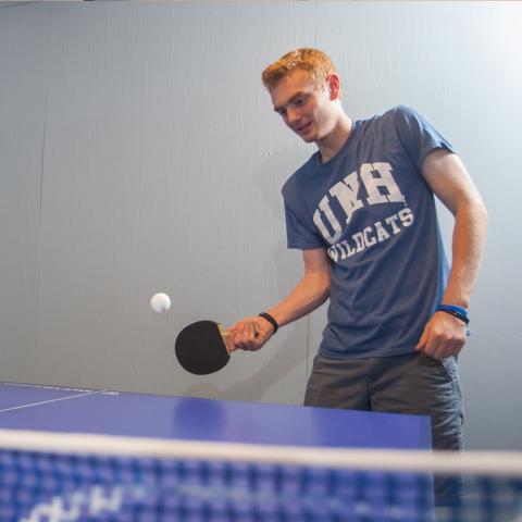 student playing table tennis