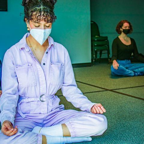 Students with masks meditating in Interfaith Space