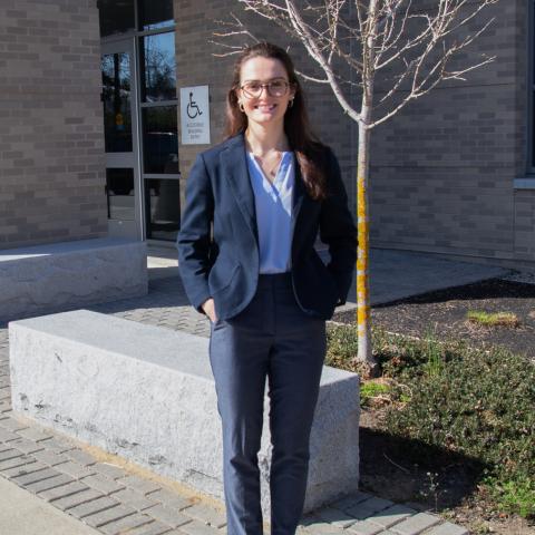 Student standing in front of the Hamel Rec Center