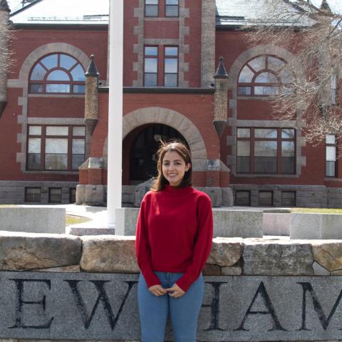 Student Standing in front of Thompson Hall