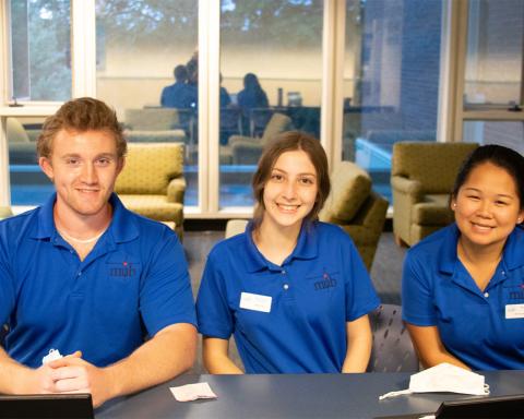 Three MUB student staff sitting at a table 