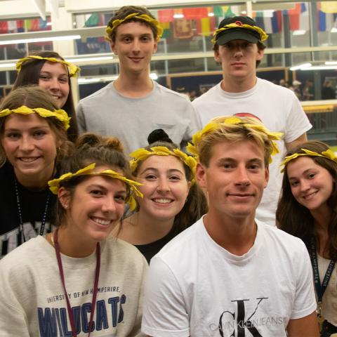 Students posing in a group with leaf crowns