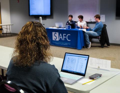 Student in front of laptop during a SAFC meeting