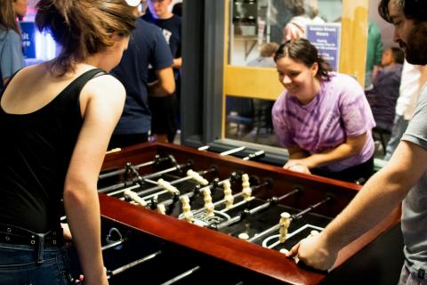 Students playing table football in Games Room