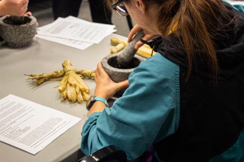 Student mashing nuts for pemmican.