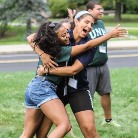 Connect students embracing at event