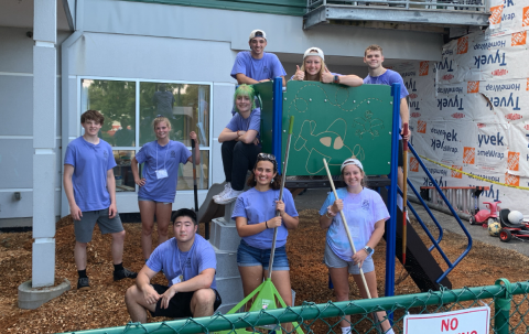 Volunteers smiling on a playground