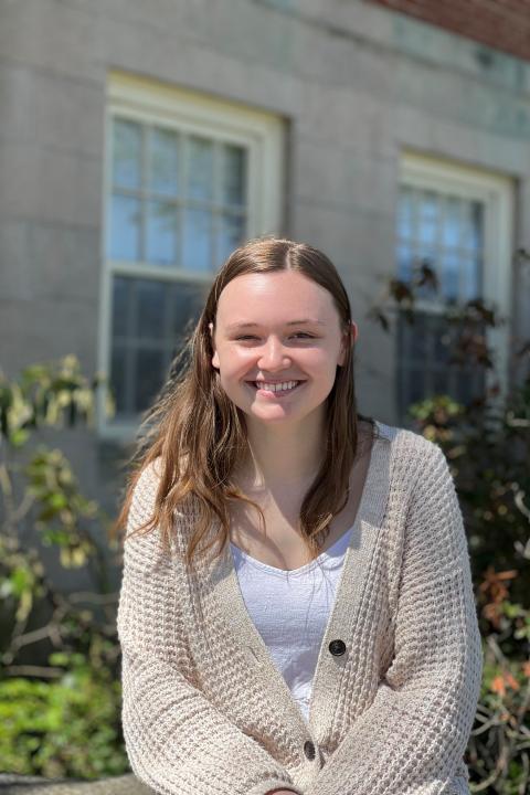Young white woman smiling outside
