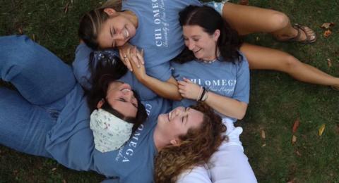 Group of women laying on the grass together