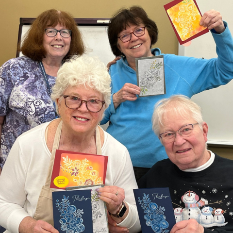 OLLI members showing of the cards they made during a creative arts course!