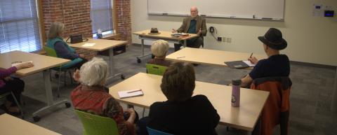 OLLI presenter Jim Mahoney teaching a course to a group of sitting members.