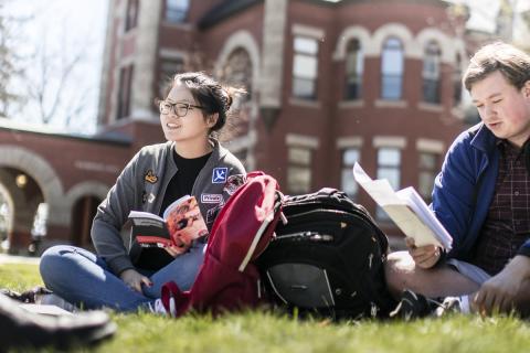 Students sitting on the lawn on campus