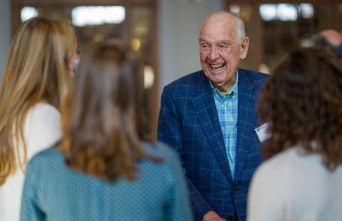 Dana Hamel smiles while interacting with three female students