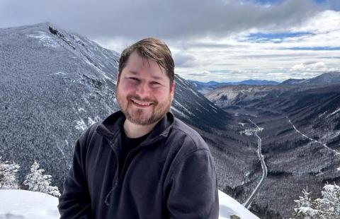 Richard Gorby headshot with snow-covered mountains and valleys in the background.