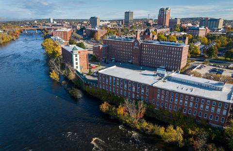 Aerial view of ӣ������ Manchester alongside a body of water in Manchester