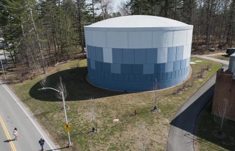 Aerial view of UNH's Thermal Energy Storage Tank, a blue and white cylindrical structure