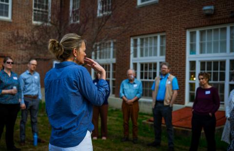 michele holt-shannon leading a group of people standing in a circle outside