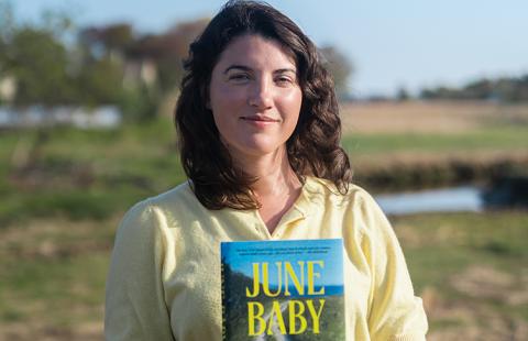 Portrait of Shannon Garvey holding a copy of "June Baby"