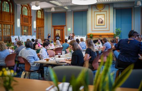 A group of people sitting at tables in the Huddleston Ballroom