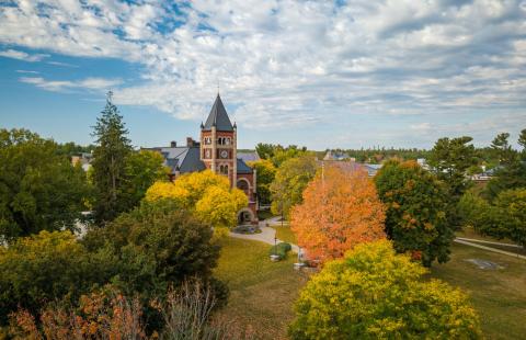 Aerial photo of ӣ������ campus in fall, with bright trees in front of T Hall