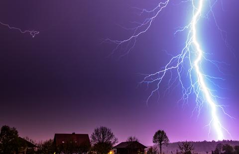 Stock photo of a lightning bolt behind a house