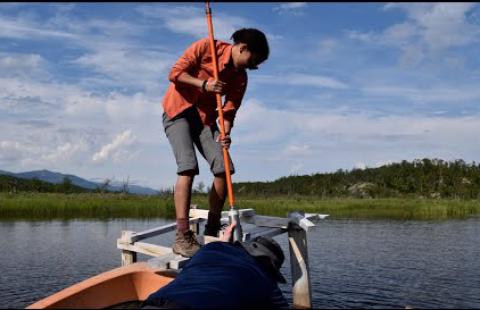 UNH student conducting research on a boat