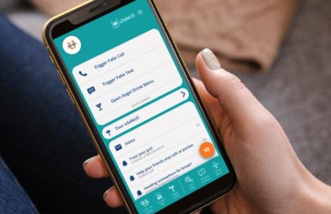Hand holding smartphone with uSafeUS app open