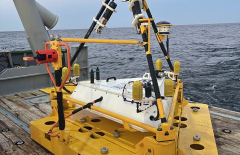 Yellow oceanographic apparatus sits on a dock