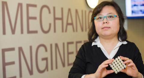 Mechanical engineering professor Yaning Li holding 3D printed square