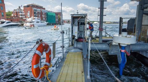 Tidal turbine platform beneath UNH's Living Bridge