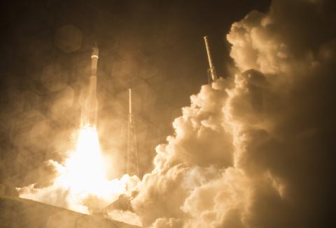 Spacecraft blasting off in cloud of exhaust